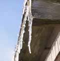 icicles are hanging from the side of a building .