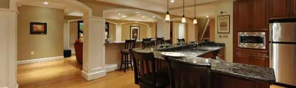 a kitchen in a basement with granite counter tops and stainless steel appliances .