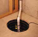 a drain in a basement with a pipe coming out of it .