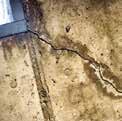 concrete wall with a crack in it to a window corner