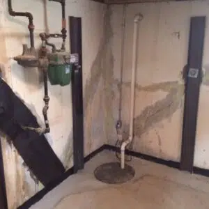 a room with pipes and a green container that says ' a ' on it