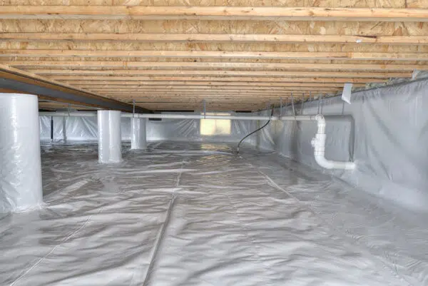 a basement filled with plastic and pipes under a wooden ceiling .