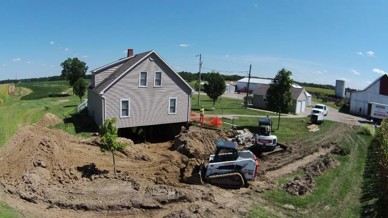 a bobcat is being used to move a house