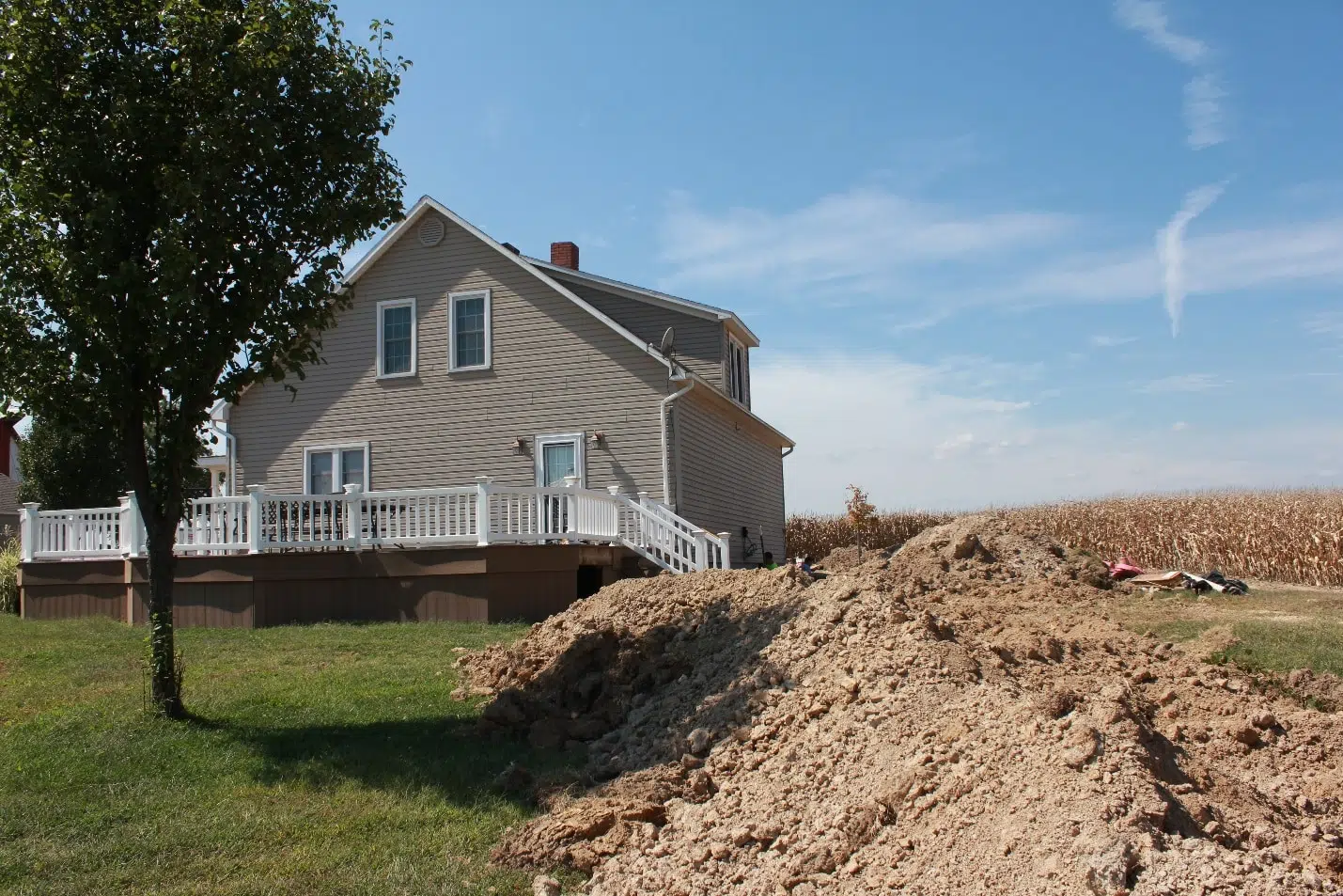 a house with a large pile of dirt in front of it