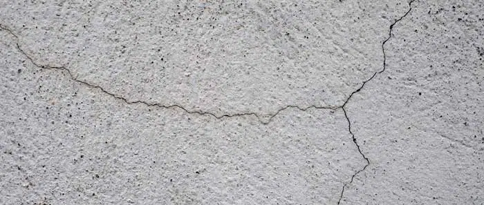a close up of a white wall with a large crack