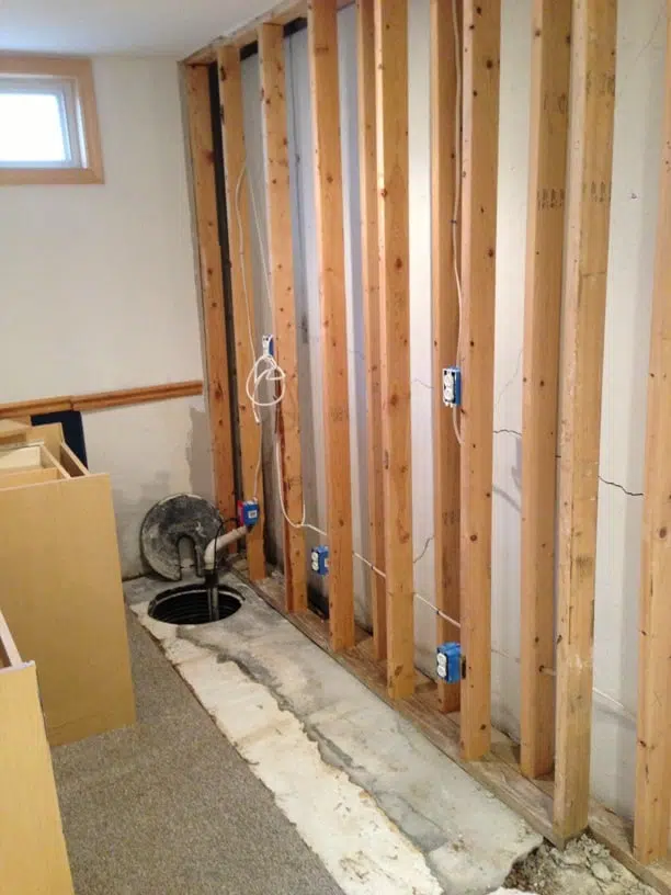 a wooden wall with a hole in it and a box that says ' electrical ' on it