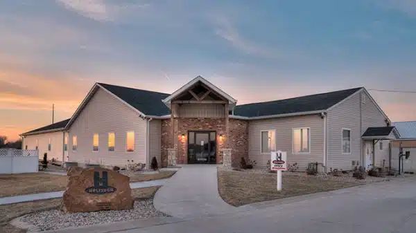 a house with a sign that says ' for sale ' on it