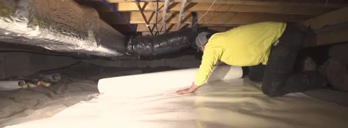 Helitech employee in crawl space
