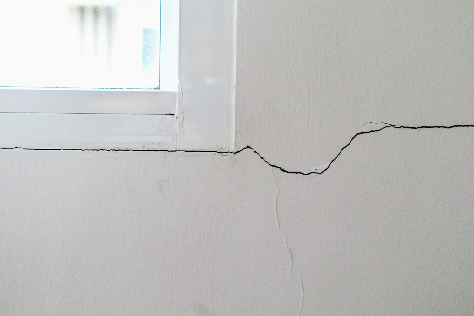 New house wall crack near window frame