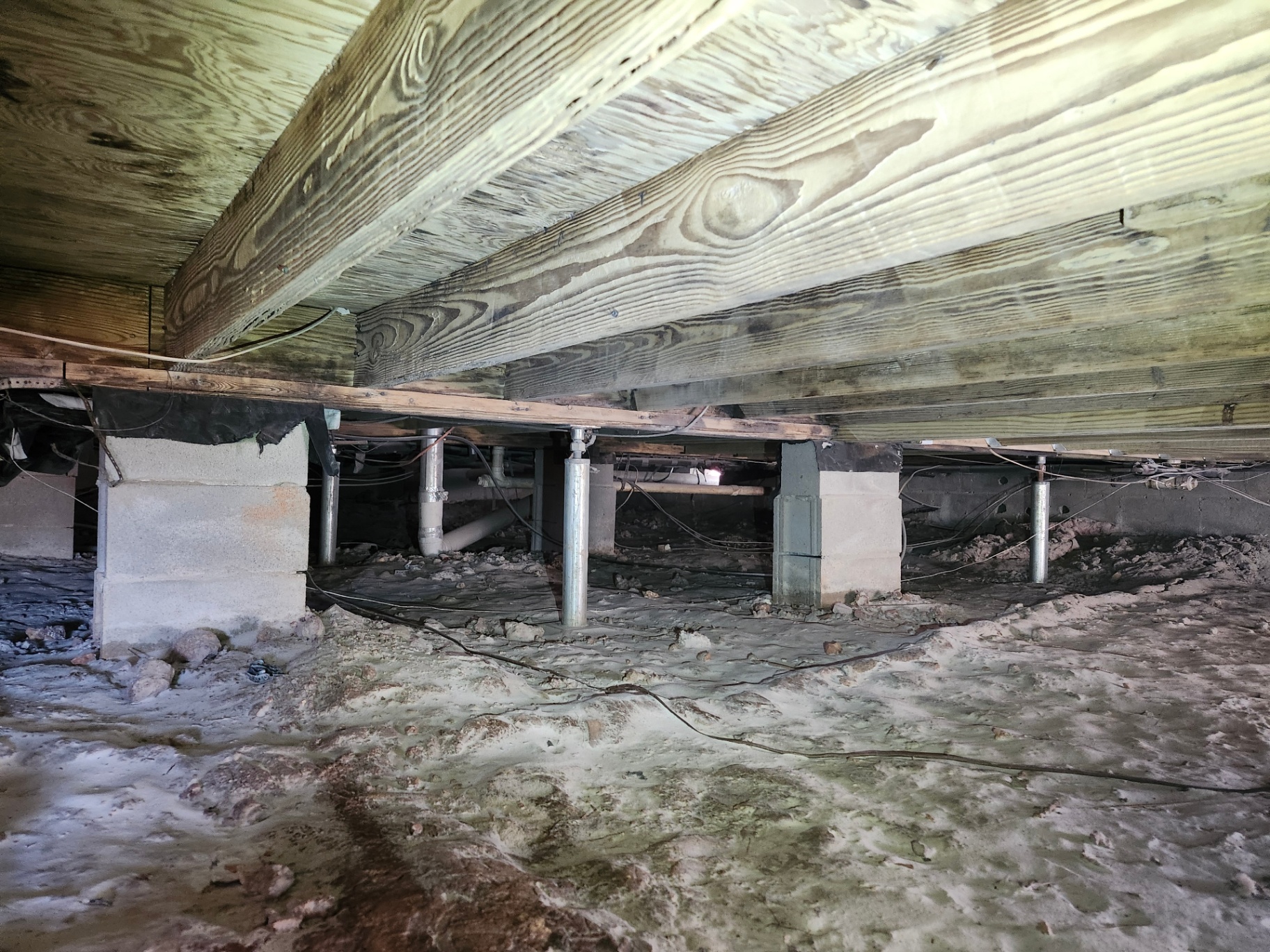Crawl space after soda blasting mold remediation by Helitech Waterproofing & Foundation Repair, showing clean, mold-free wood joists and improved structural integrity.
